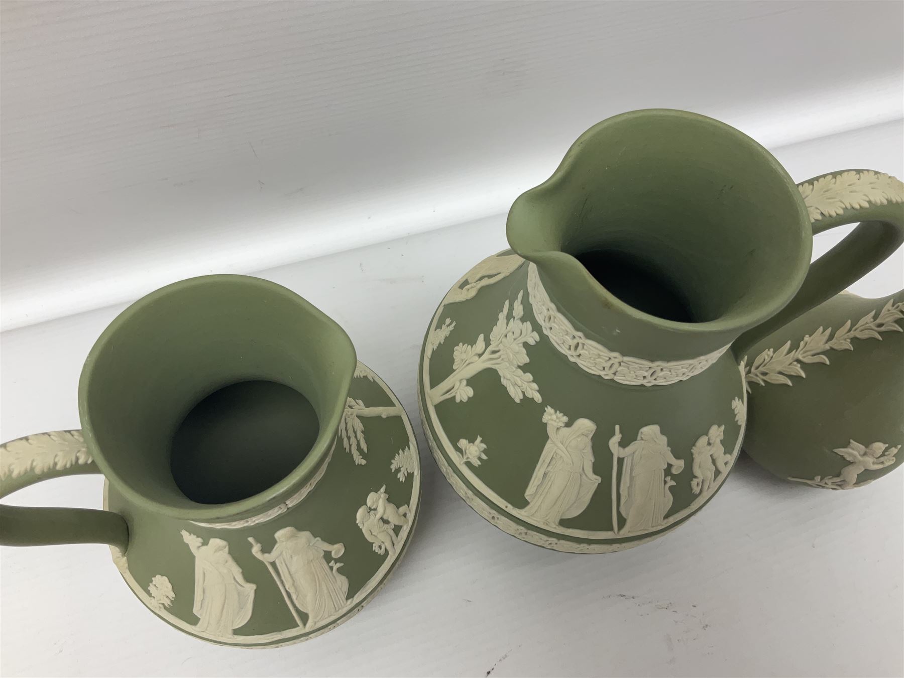 Collection of  Wedgwood green Jasperware, to include large jug, vases, trinket dishes, etc together with two teal Jasperware vases 