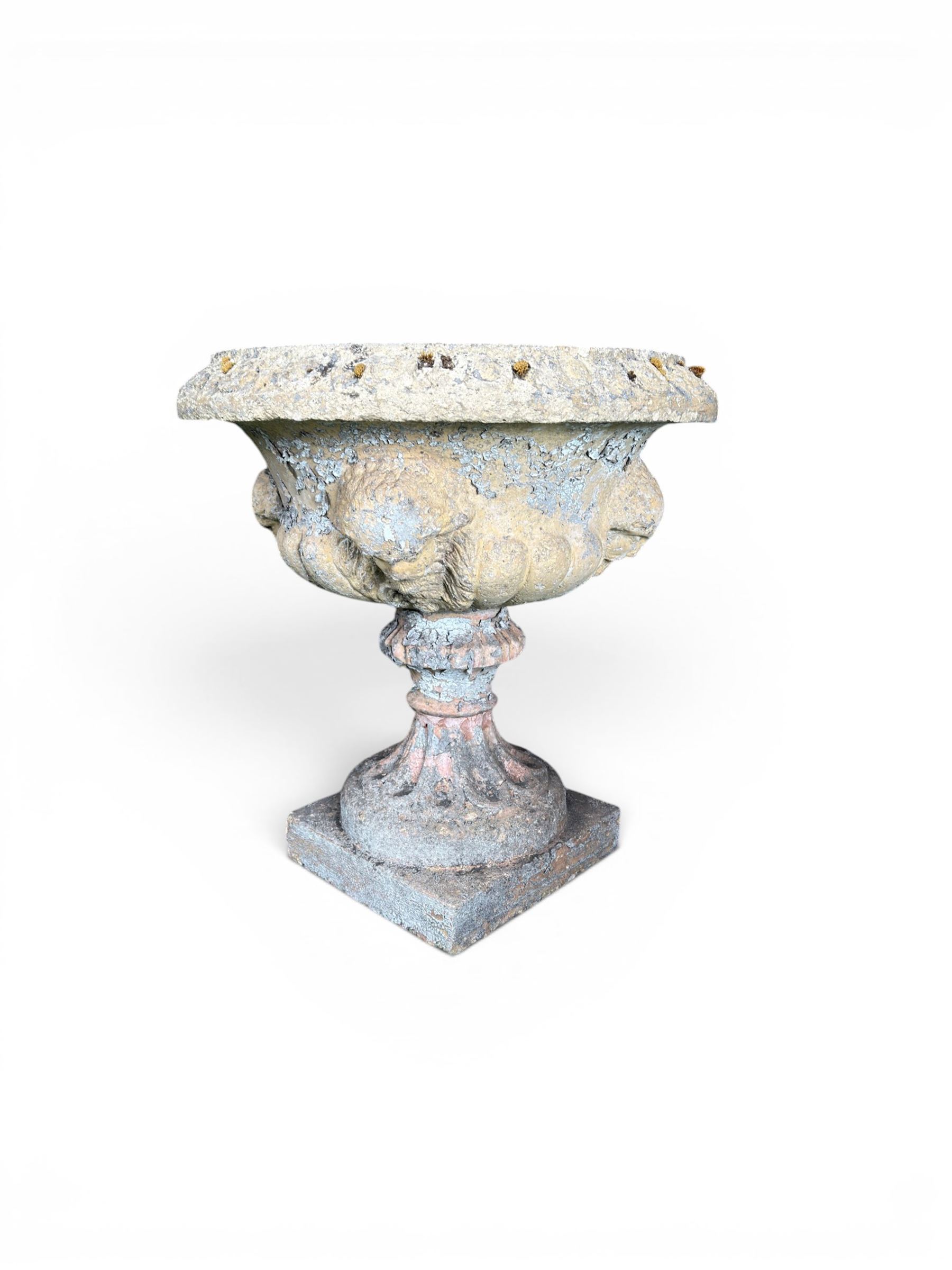 19th century terracotta campana shape urn planter, egg-and-dart moulded rim over a cherub-mask and gadrooned underbelly, turned pedestal and socle on square base