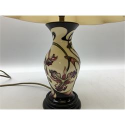 Moorcroft table lamp, of baluster form, decorated with pink iris on a white ground with accompanying cream shade of lobed form, with piped detail, H47cm