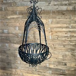 Pair of black finish wrought metal hanging baskets, with brackets