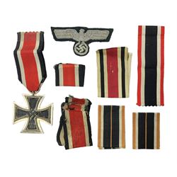  WWII German Iron Cross 2nd Class, the suspension ring stamped 128 for S. Jablonski G.m.b.H. Posen; with ribbon; together with an embroidered cloth eagle badge and quantity of German medal ribbons.