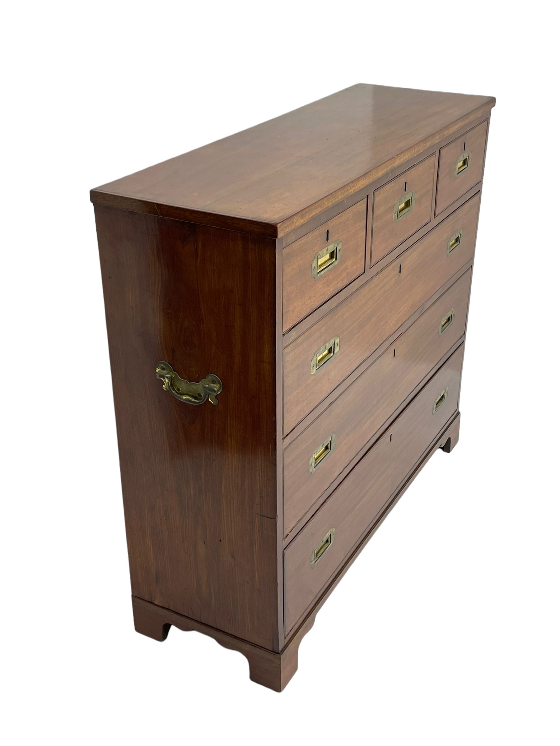 Georgian military type campaign chest, narrow rectangular top over three short and three long drawers, recessed brass handles, on bracket feet