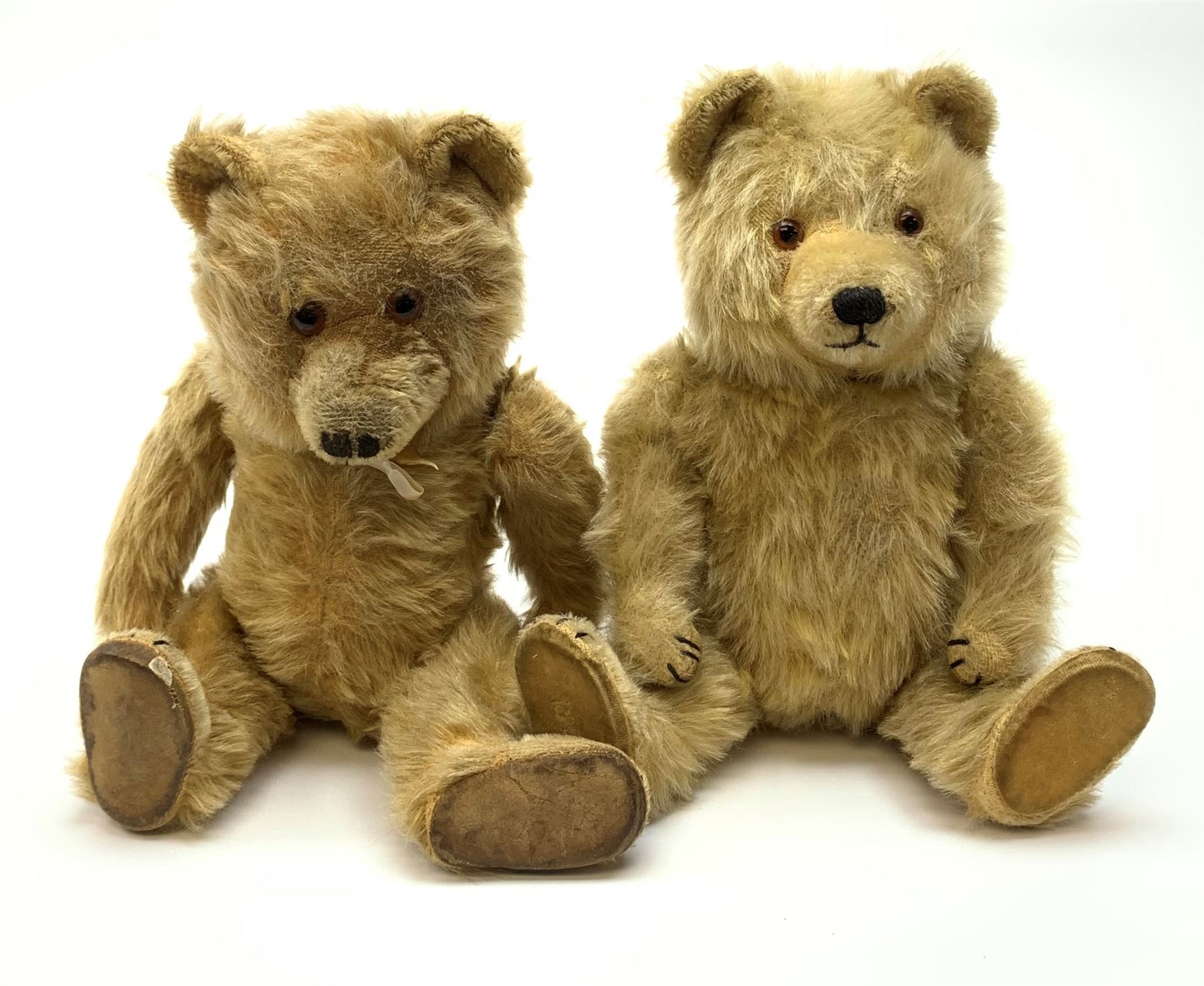 Chiltern Ting-a-Ling teddy bear c1950s with blond mohair body, swivel jointed head with glass eyes and vertically stitched nose and mouth, jointed limbs with velvet pads and card lined feet and internal chimes H14