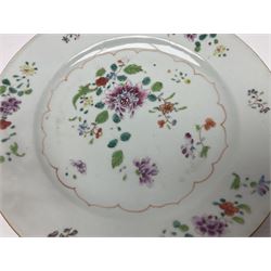 Three 18th century Chinese Famille Rose plates, the first example enamelled with blossoming peonies, rockwork and fence, the other two examples of similar design, decorated with blossoming peonies and sprigs within shaped inner borders, each approximately D23cm