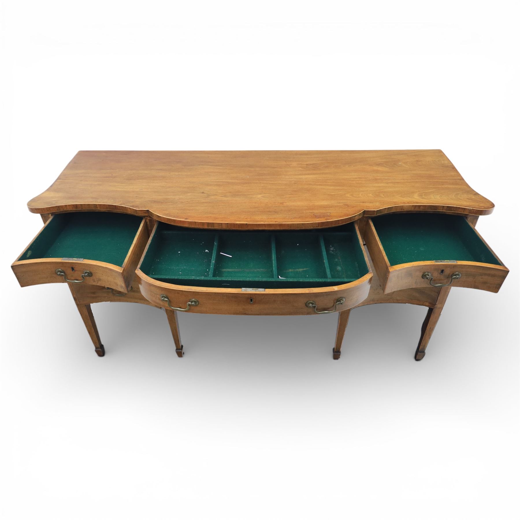 Early 20th century mahogany bow front sideboard, the shaped and moulded top above central kneehole recess with baize lined frieze drawer, flanked by twos drawers either side with the lower drawer double height, raised upon square tapering legs with spade feet