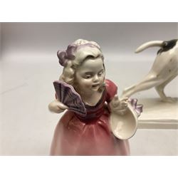 Early 20th century Katzhütte figure of a pointer dog, and figure of a young girl holding basket and fan, both with green cat H house printed mark beneath, dog L25cm