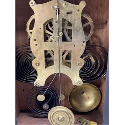 Fattorini of Bradford - oak cased early 20th century mantle clock with alarm, rectangular case with a broken pediment, turned finial and matching carved pilasters to the front, on a broad stepped plinth with a flat base, circular dial with an ivorine chapter within a decorative gilt bezel, Arabic numerals , spade hands and alarm setting disc to the centre, two train spring driven movement striking a coiled gong and bell. With key and pendulum. 