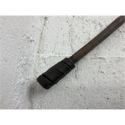 Native long-shafted spear, the large iron head with central medial ridge and decorative neck, on plain circular haft L260cm; and another similar Native long-shafted spear with cane haft L249cm (2)