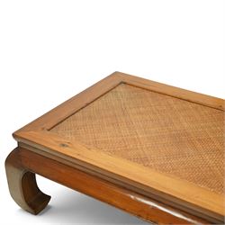 Chinese hardwood low coffee table, rectangular framed top inset with woven cane panel, mitred moulded edge, plain apron, raised on shaped and out-scrolled end supports joined by stretchers