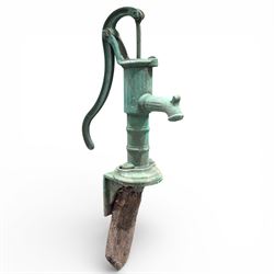 Cast stone bird bath on pedestal with cast iron water pump