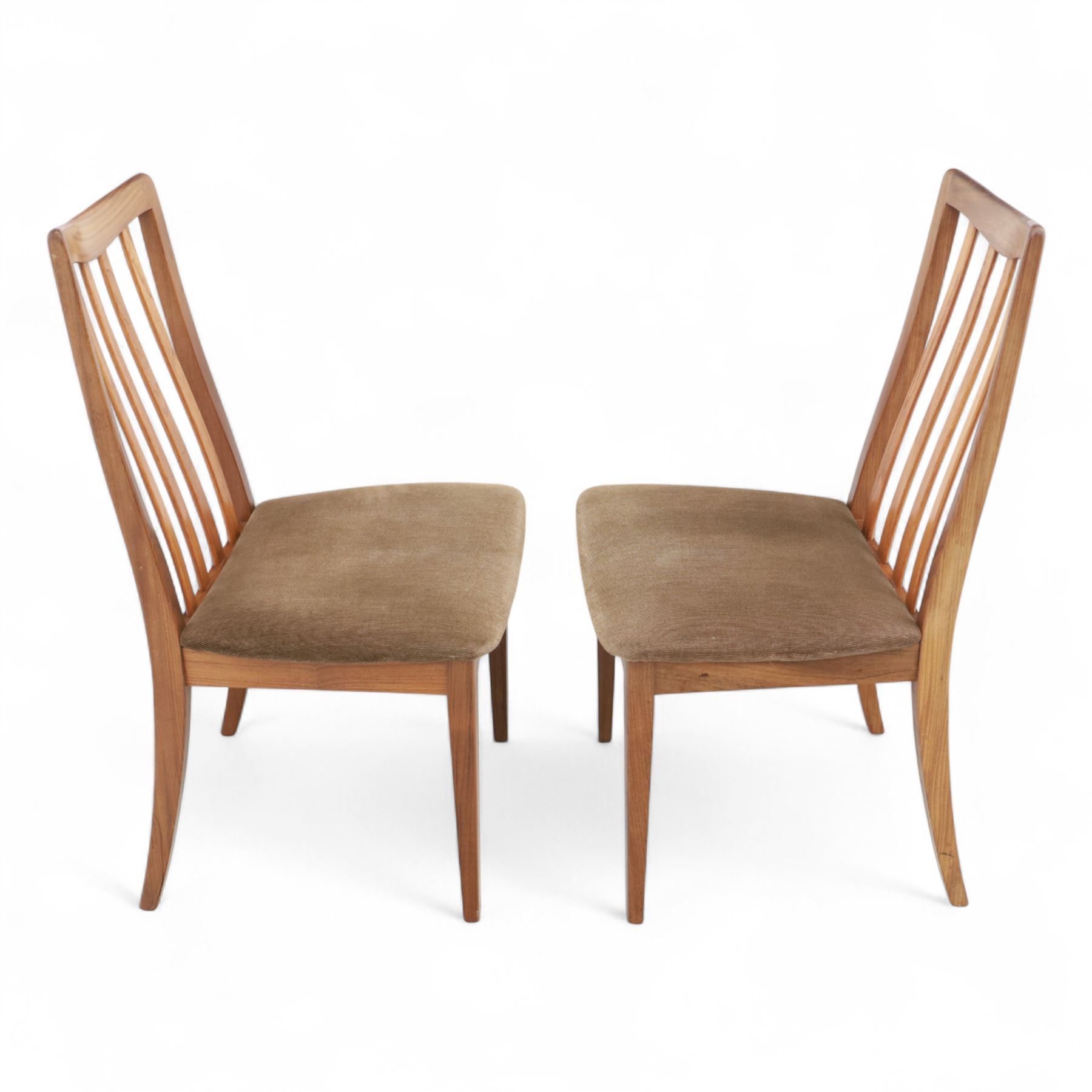 G Plan - mid-20th century teak extending dining table, oval top with integrated extension leaf, raised on tapering legs, together with a set of six slat back dining chairs including two carvers, upholstered in dark green velour (Extends to 210cm)