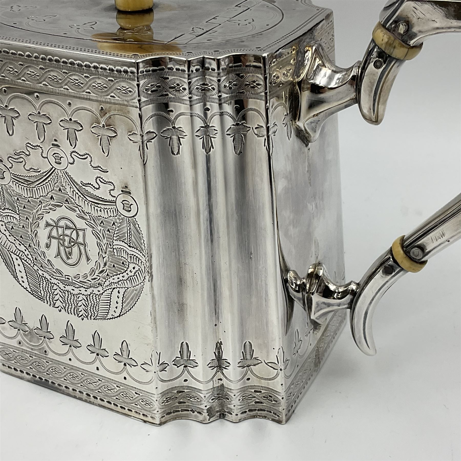 Victorian three-piece silver tea service, comprising teapot, twin handled open sucrier and milk jug, of oval form with shaped rim and C handles, each engraved with crests and bands of strapwork decoration, the milk jug and sucrier with gilt interiors, hallmarked Josiah Williams & Co, Exeter 1881, the teapot with ivory insulators and finial, all contained with a tooled leather, blue silk and velvet lined fitted case, retailed by West & Sun, Dublin 
This item has been registered for sale under Section 10 of the APHA Ivory Act