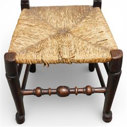 Set of five 19th century elm spindle back chairs, with shaped crest rails above double rows of turned spindles, rush seats, turned legs joined by stretchers supported on turned pad feet