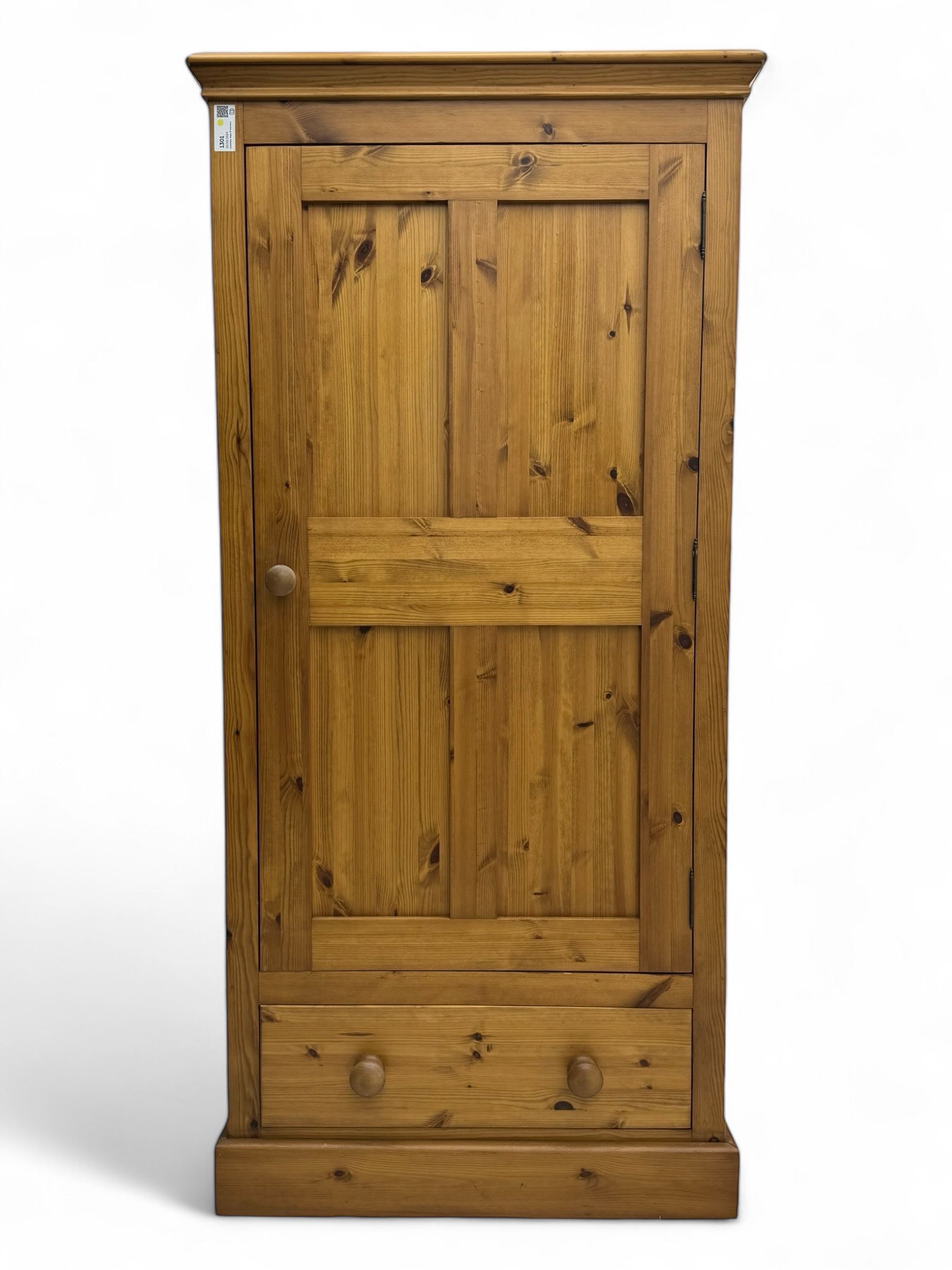 Pine single wardrobe, enclosed by single panelled door, fitted with single drawer, on plinth base 