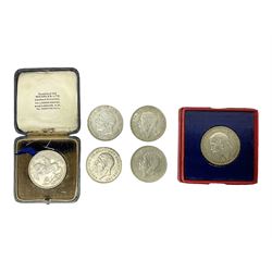 Six King George V 1935 silver crown coins, one housed in red card box and one in blue hinged case with gilt lettering to the front