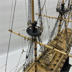 Wooden kit built model of HMS Neptune, 1:90 scale, with detailed rigging to three masts and a row of cannons to either side, upon ebonised wooden base, including stand H71cm