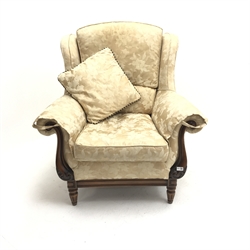 Traditional style armchair upholstered in a patterned pale gold fabric, scrolling arms, turned supports, W94cm