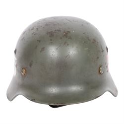 German Third Reich Waffen-SS M35 double decal helmet, the left inner brim stamped SF64, the back inner brim stamped 3866, with leather eight tongue liner and chinstrap