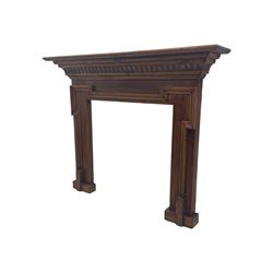 Victorian stained pine fire surround, projecting cornice with dentil moulding, panelled frieze and chamfered uprights on block supports