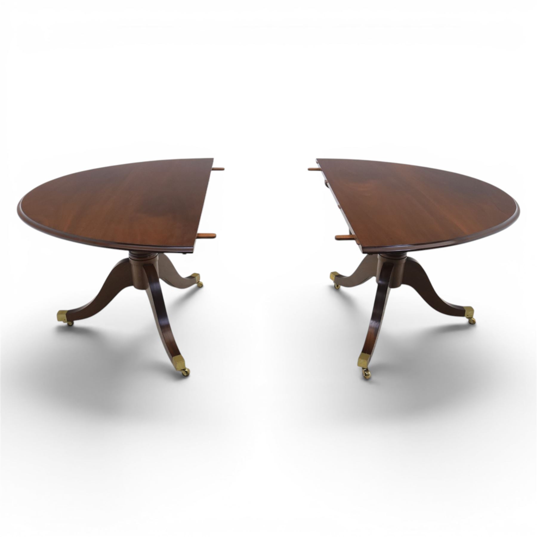 Gott's Pickering - Quality Georgian design rosewood twin pillar extending dining table, with additional leaf, oval form raised on turned columns with tripod legs on cast brass sockets and castors, complete with brass coupling forks, length 164cm without leaf