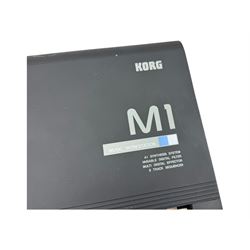 Korg M1 keyboard synthesiser, 61 velocity-sensitive keys with integrated multi-effects and eight-track sequencer, mounted on an adjustable black tubular X-frame stand with rubber end caps