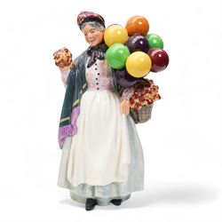Four Royal Doulton figures comprising 'Sweet Lavender' HN1373, 'The Balloon Seller' HN583, 'Biddy Pennyfarthing' HN1843 and 'Silks and Ribbons' HN2017 (4)