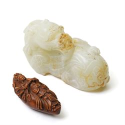 Chinese green hardstone carved dragon, W12cm; together with a carved wooden thousand-hand ...