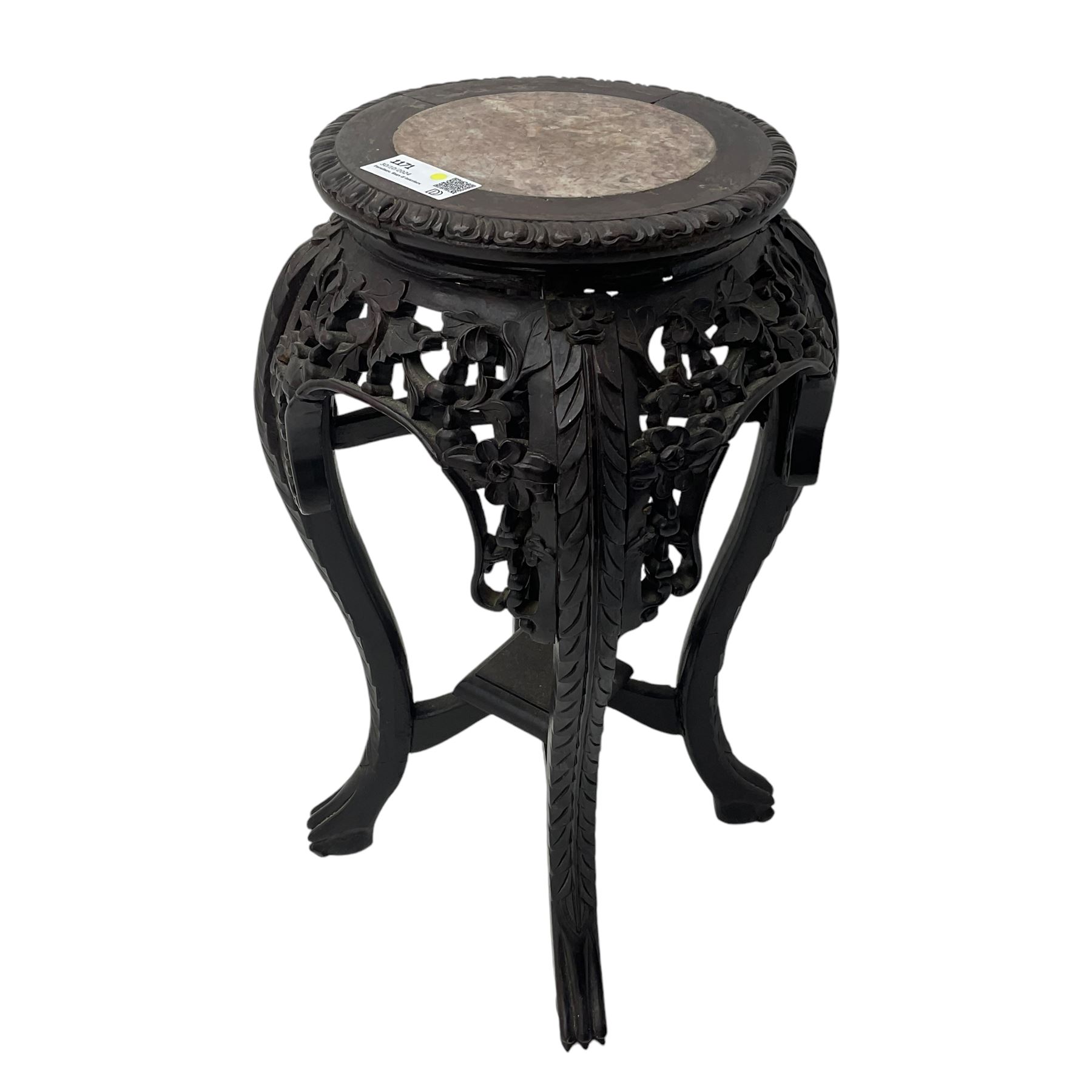 Late 19th century Chinese hardwood pedestal stand, circular top with inset marble panel, carved apron with openwork foliate and floral motifs, raised on cabriole supports with stylised claw and ball feet united by square undertier
