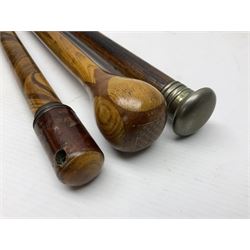 Three early 20th century walking sticks, to include a smoking pipe walking stick, the cane opening to reveal a concealed pipe, and a wooden walking cane, the metal cover with inscription 'bell metal and wood of York Minster, Burnt May 20 1840, and a turned wooden walking stick, with marquetry checkerboard pommel, tallest L90cm