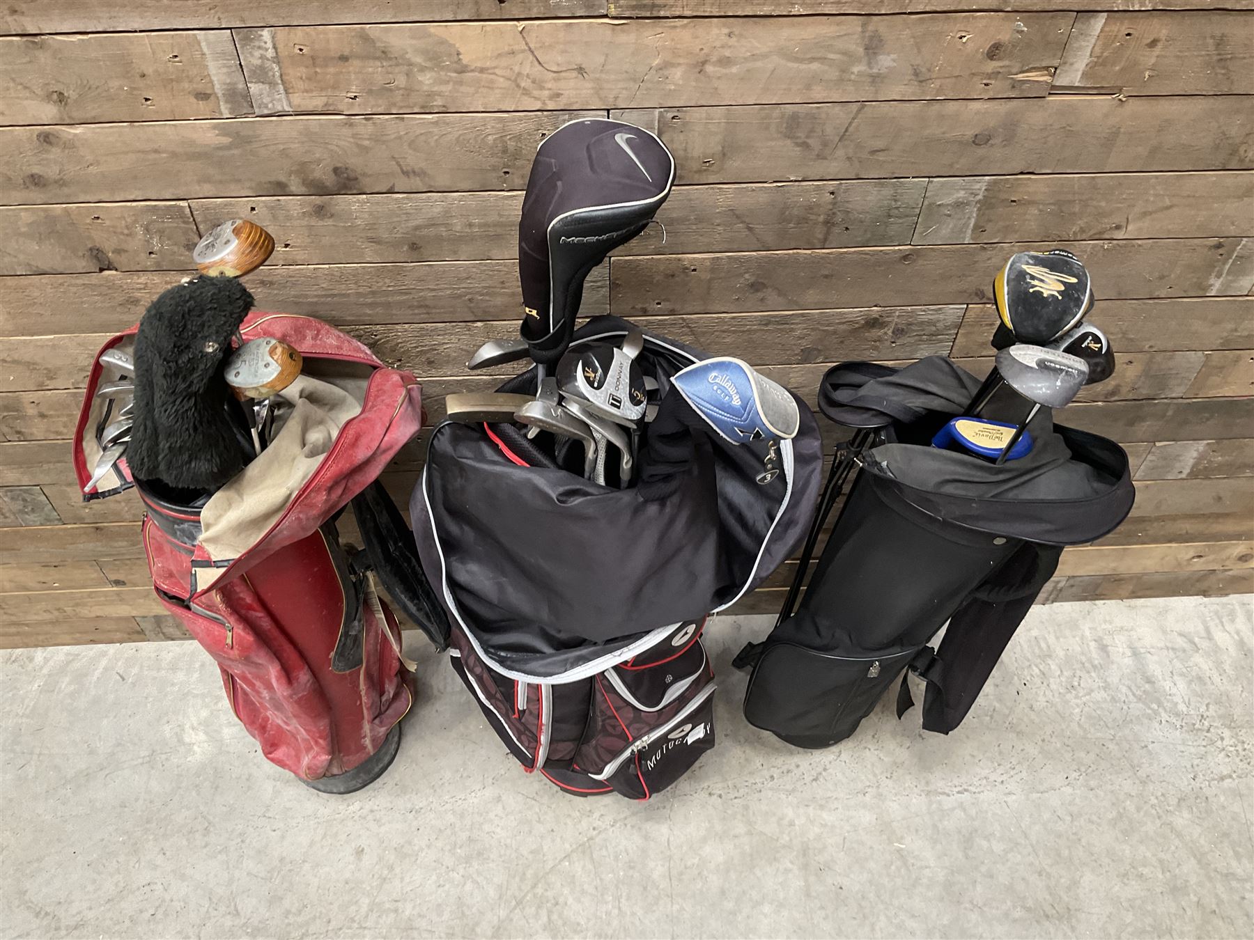 Various golf clubs in three bags