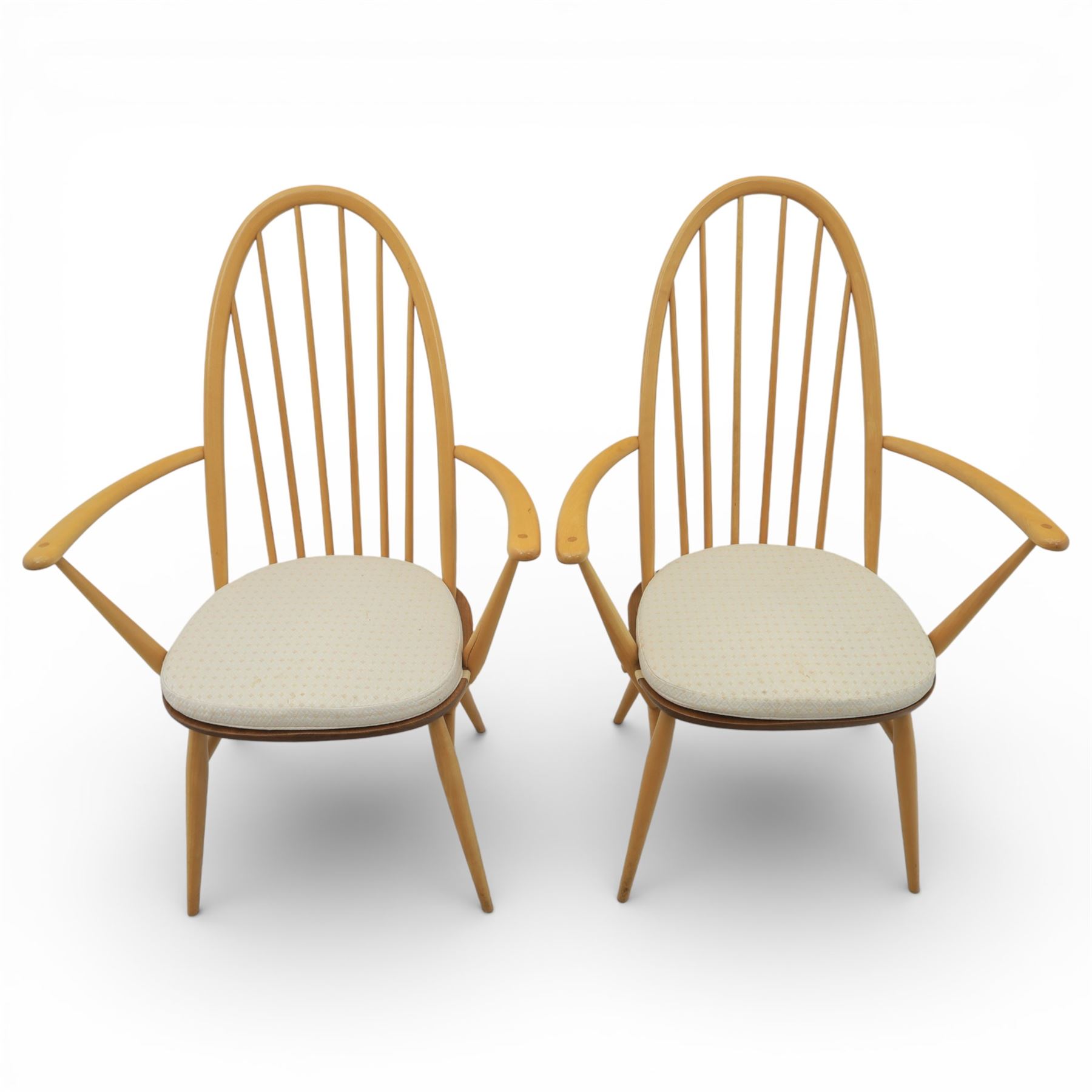 Ercol - elm dining chairs, set of six including two armchairs, arched spindle backs over shaped elm seats with upholstered pads, tapering beech legs joined by stretchers