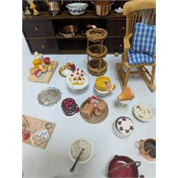 Victorian and later style dolls house kitchen furniture, including countertop, dresser displaying copper pots and blue and white ceramics, baking table, oven, three figures and a collection of food and baking accessories