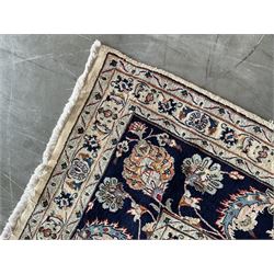 Large Persian Heriz carpet, ivory ground with trailing floral design and decorated with stylised flower heads, matching design to blue ground boarder, multiple guards with foliate decoration 