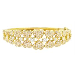 18ct gold diamond heart bangle, two rows of eleven graduating heart motifs, each set with pave set diamonds, spaced by ten round brilliant cut diamonds, total diamond weight approx 1.90 carat