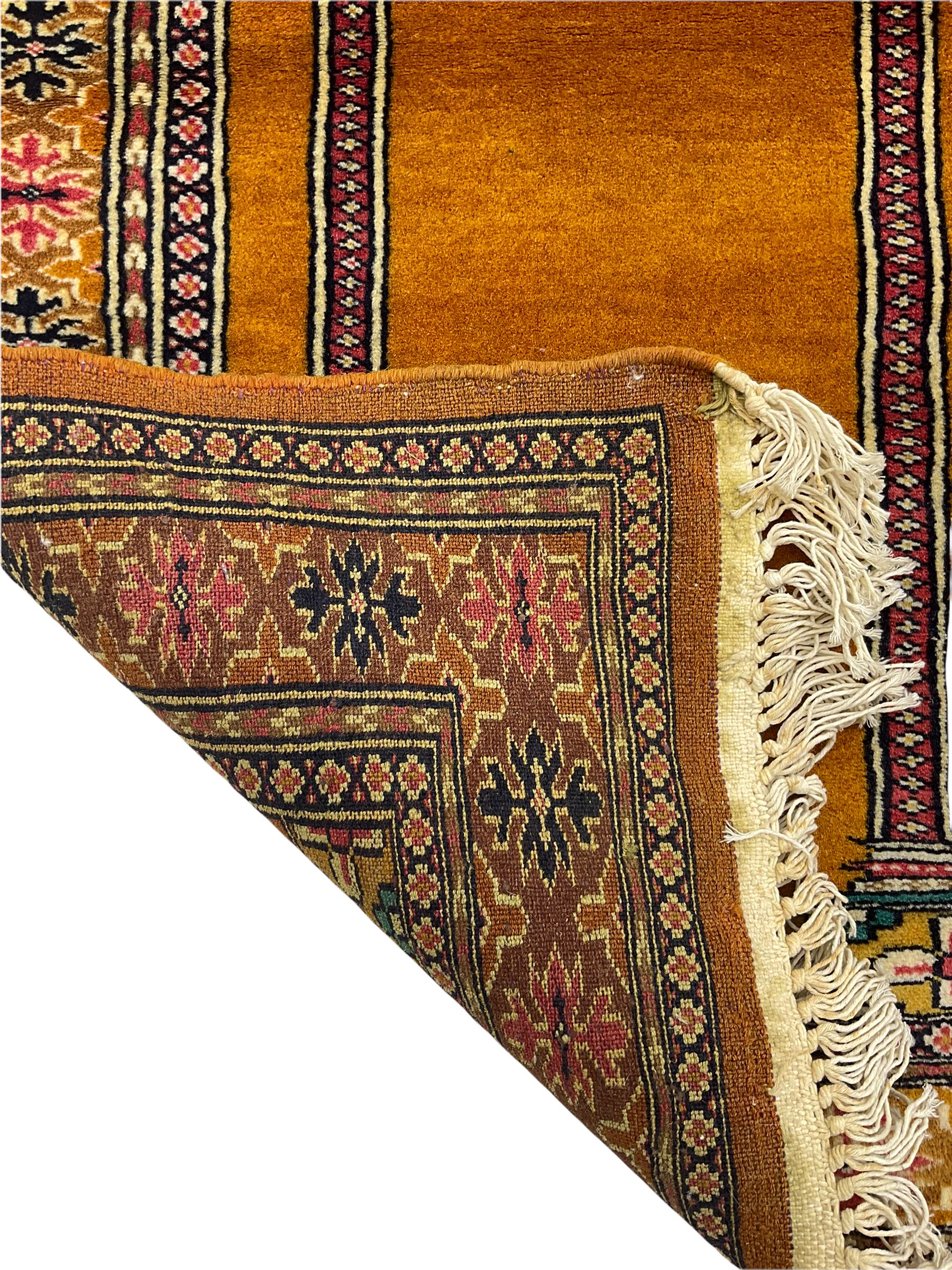 Angle-poise lamp and an Islamic prayer mat