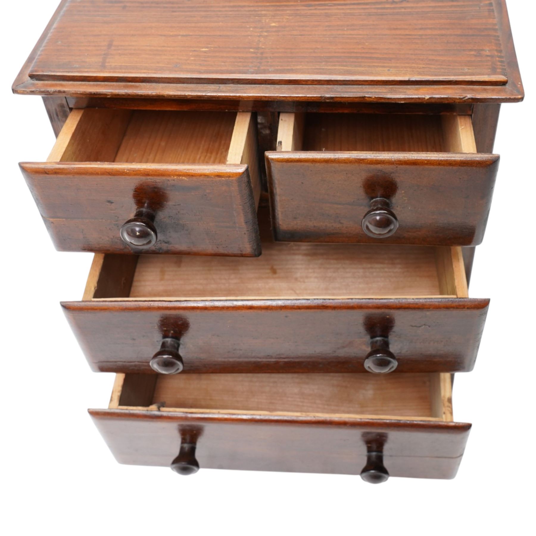 Miniature stained pine chest of two long and two short drawers above a shaped apron W28cm