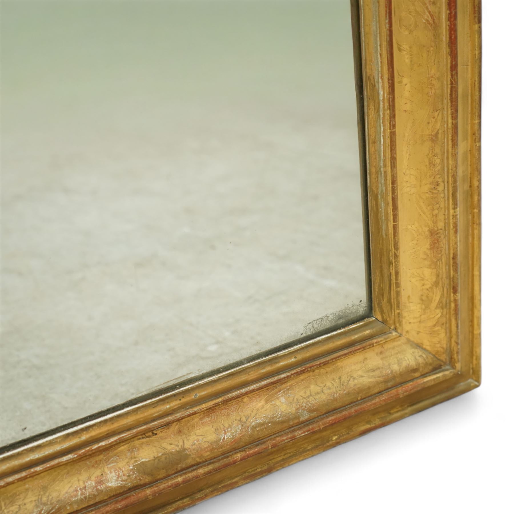 Louis XVI style gilt overmantel mirror, arched rectangular form with moulded frame, surmounted by a pediment carved with ribbon-tied grapevine and leaf decoration, enclosing a plain mirror plate, circa 1900