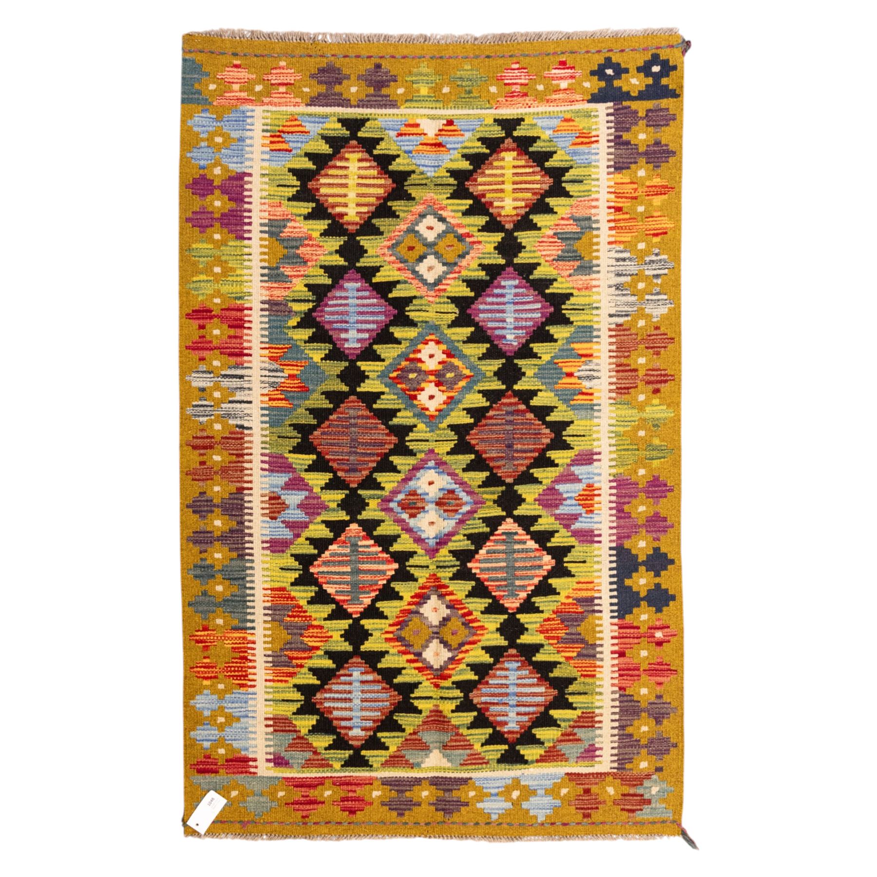 Afghan Maimana flatweave kilim, central field features large bold nested diamond motifs and stylized geometric lozenge patterns on olive purple, blue, and green tone ground, border stripe in mustard ground, and fringe