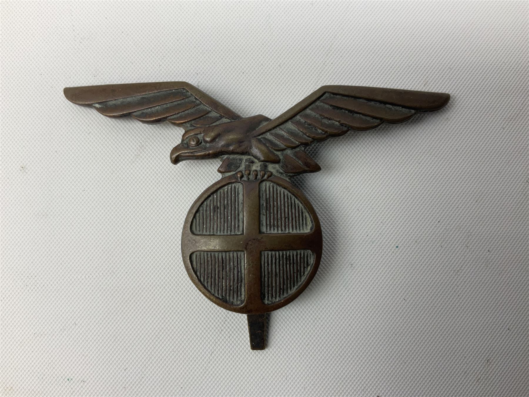 Three WW2 German visor cap badges comprising Police eagle, Political leaders eagle and Norwegian Quisling Party; all with fixings; and WW2 Polish visor cap badge (4)