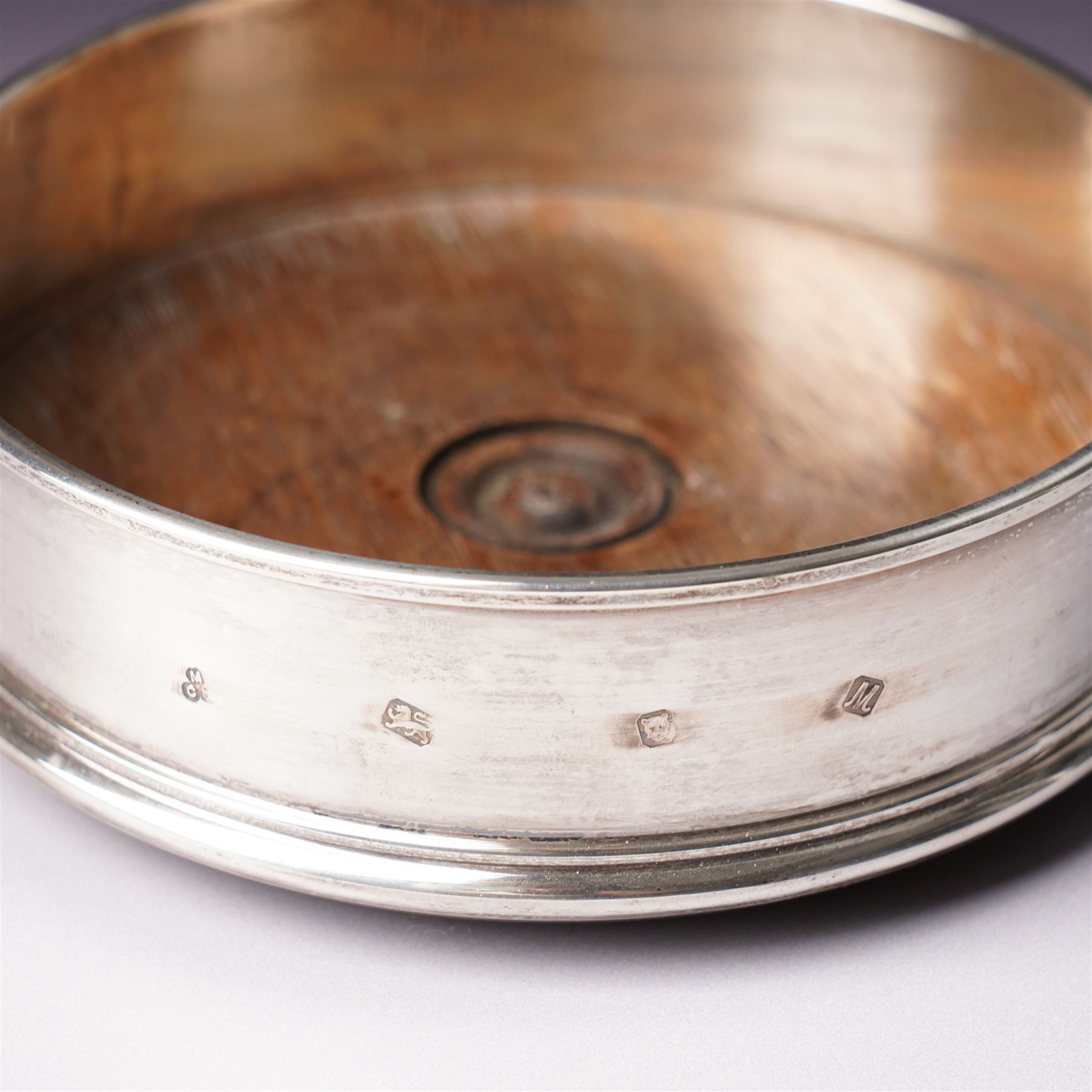 German 925 standard silver cigarette box with hinged lid  and a silver bottle coaster with turned wood base London 1986 Maker M C Hersey & Son