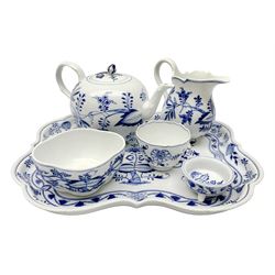 Late 19th/early 20th century Meissen blue and white Onion pattern part cabaret set, comprising shaped tray, teapot with flower bud finial and crabstock handle and spout, footed jug, quatrefoil dish, open sucrier, and small footed dish, each with blue crossed sword mark beneath, tray L38cm, teapot H14.5cm 