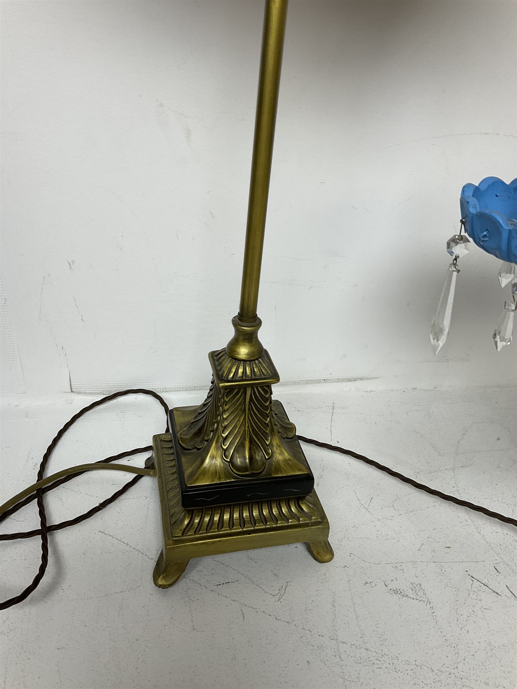 Brass table lamp, modelled as a candelabra with five branches, each with blue glass candle holders with crystal drops, H47cm, together with a pair of cast metal table lamps with acanthus leaf detail, upon a stepped square base, with red fabric feather and tassel shades, H78cm