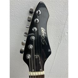 Stagg heavy metal style six-string electric guitar, finished in black with chrome tuning pegs, fret markers and humbucker pickups to bridge L106cm; and Hondo USA electric guitar with black body, ivory coloured pickguard and mother-of-pearl fretmarkers L101cm (2)   