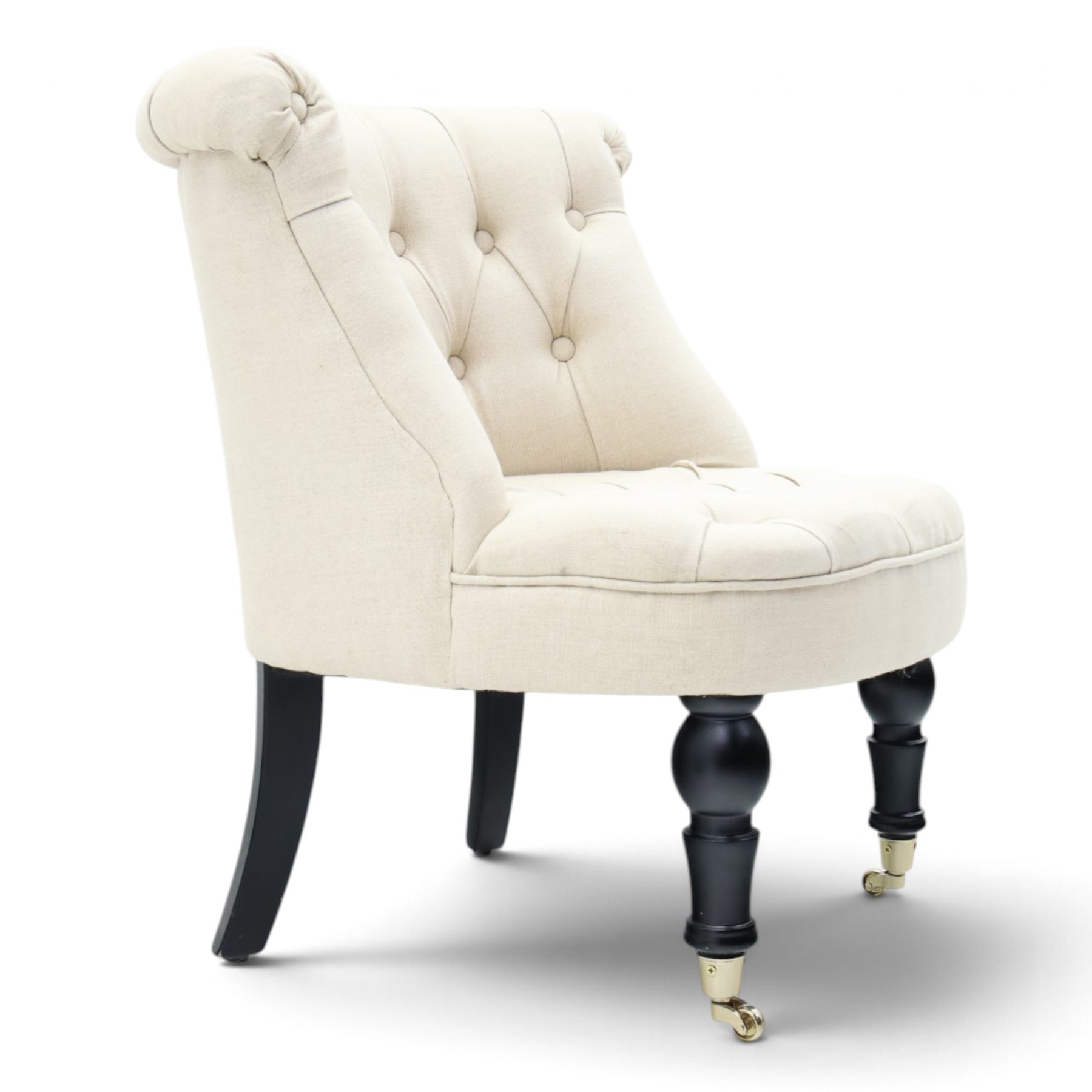 Victorian style upholstered tub chair, buttoned cream fabric back and seat with rolled sides, on ebonised turned front supports with brass castors and splayed rear supports
