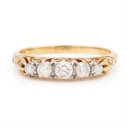Early 20th century gold diamond ring, set with five graduating old cut diamonds, with scro...