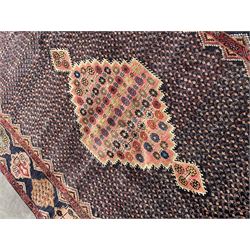 Persian Hamadan blue ground rug, medallion on field decorated with repeating motifs, the guarded border with multiple medallions decorated with flower heads and stylised motifs