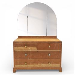 Early 20th century Art Deco bedroom suite, comprising double wardrobe, dressing table and chest of drawers, constructed in walnut with figured veneers and geometric banding, the wardrobe with arched top and panelled doors enclosing a fitted interior, the dressing table with rectangular top below a three panel mirror arrangement, fitted with two short over two long drawers, the chest with three short and three long drawers, each piece fitted with faceted handles and raised on shaped feet
Wardrobe (H 177cm, D 46cm, W 112cm)
Chest (H 85cm, D 48cm, W 92cm)
Dressing table (H 160cm, D 52cm, W 106cm)
