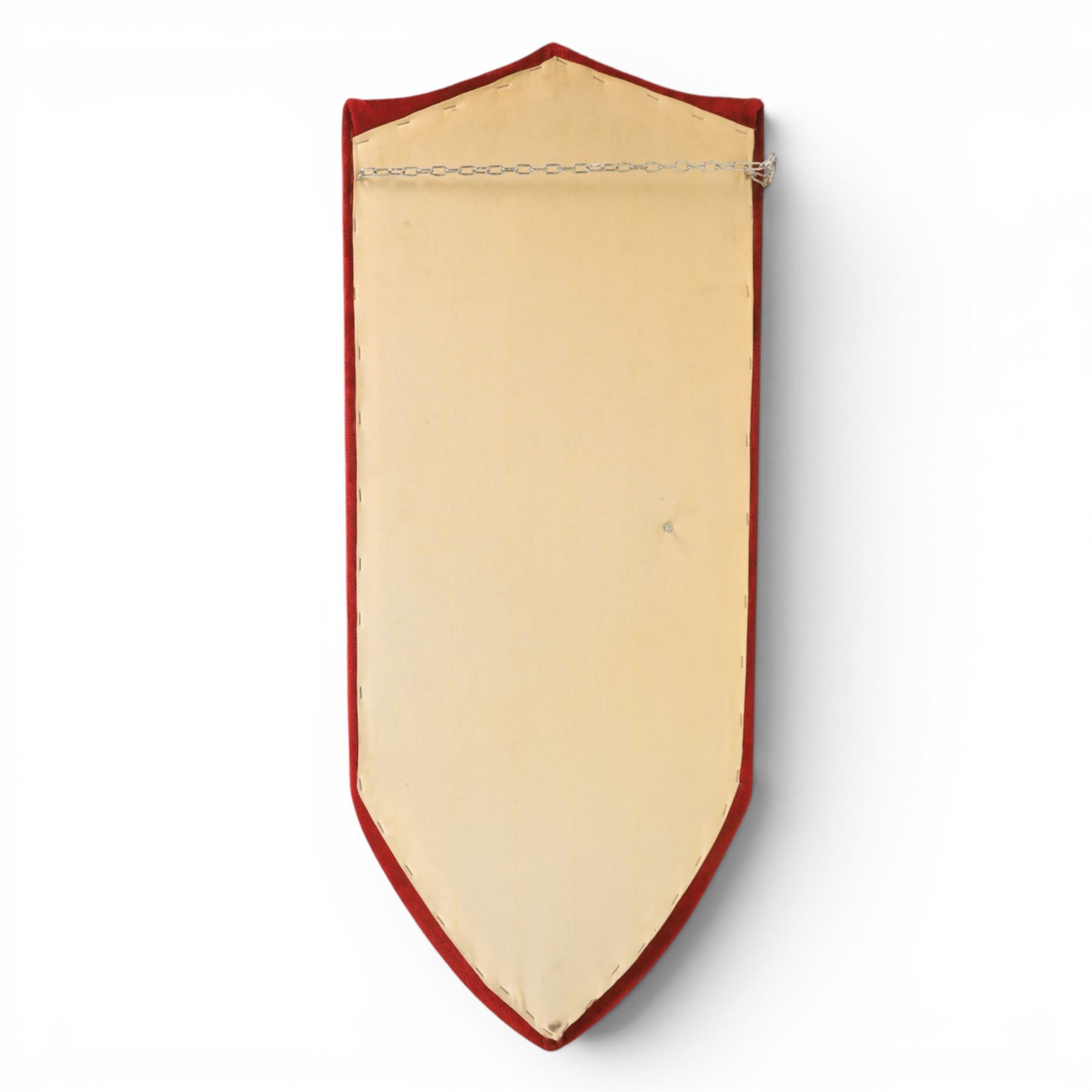 Three replica gauntlets, each housed upon a red wall shield, two with daggers, the third with a sword, largest H102cm