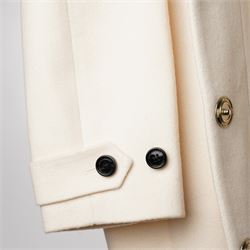 Burberry London - wool coat in cream, with concealed front popper fastening, bracelet-length sleeves with tab and black button detail and side slip pockets, with slit to back, size 40, unused with original Harvey Nichols garment bag and hanger