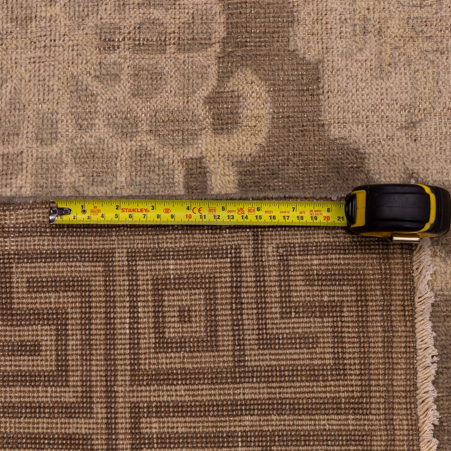 Indian Khetar hand knotted carpet, the brown ground decorated with an all over scrolling foliate and palmette design, enclosed within a conforming floral border with guard stripes